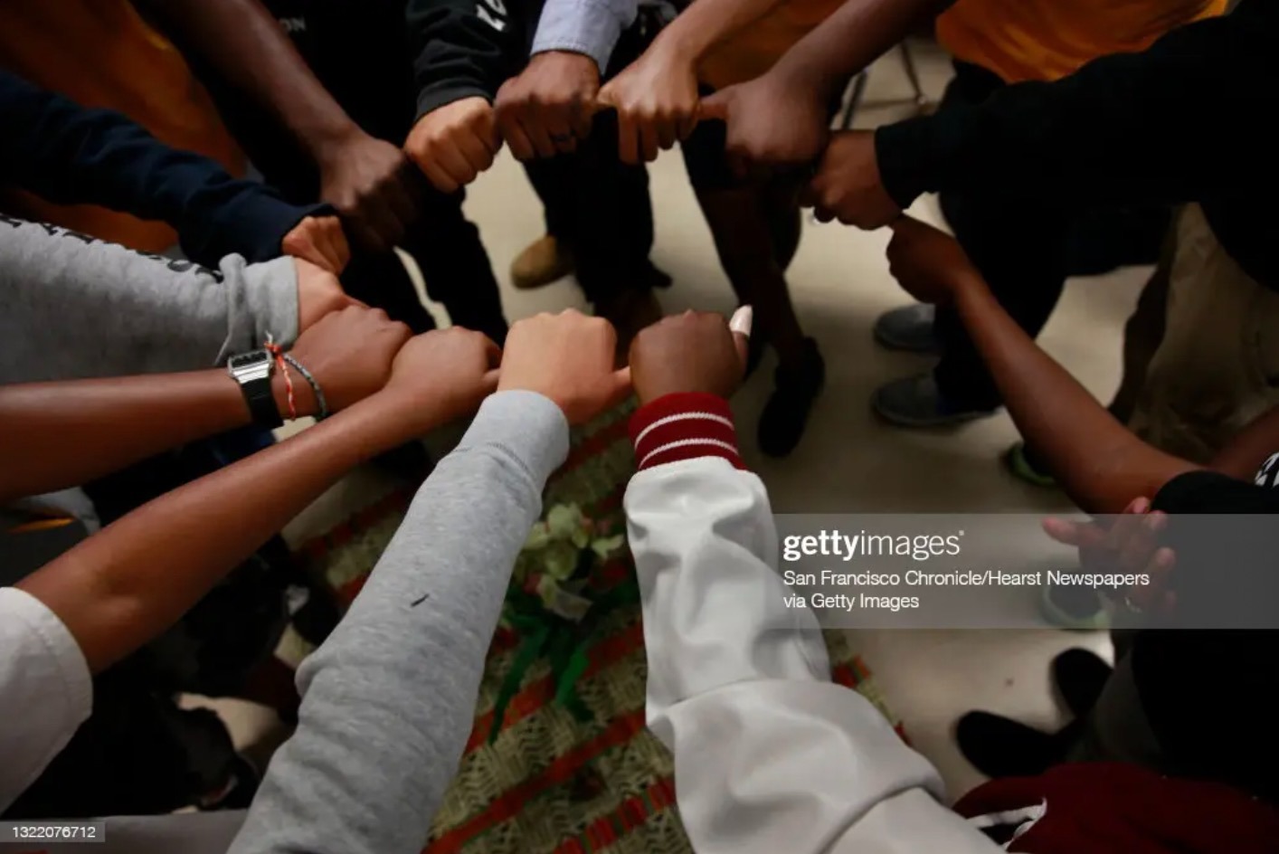 A Restorative Justice coordinator has students link thumbs to form a circle